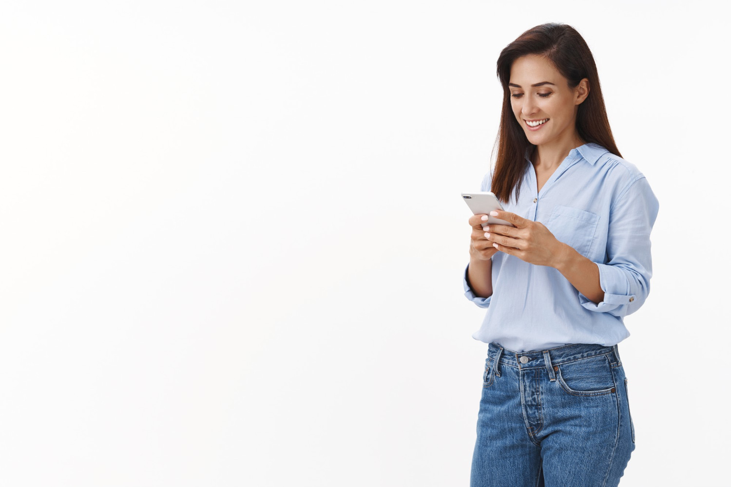 carefree cheerful female entrepreneur waiting take away coffee order lunch online app smiling delighted hold smartphone read text message phone screen stand white wall upbeat